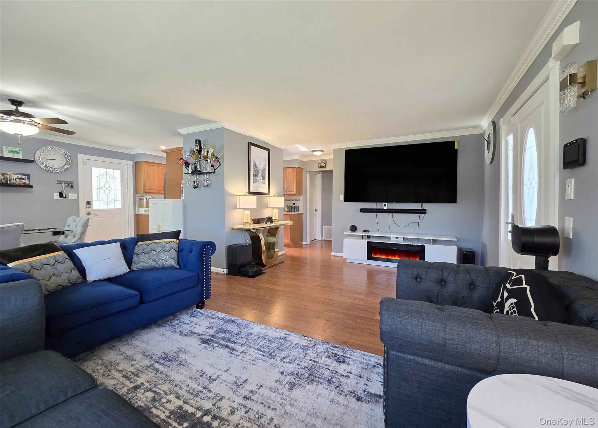 6 Virginia Road Centereach, NY 11720 - Photo 4 of 23 a living room with furniture and a flat screen tv