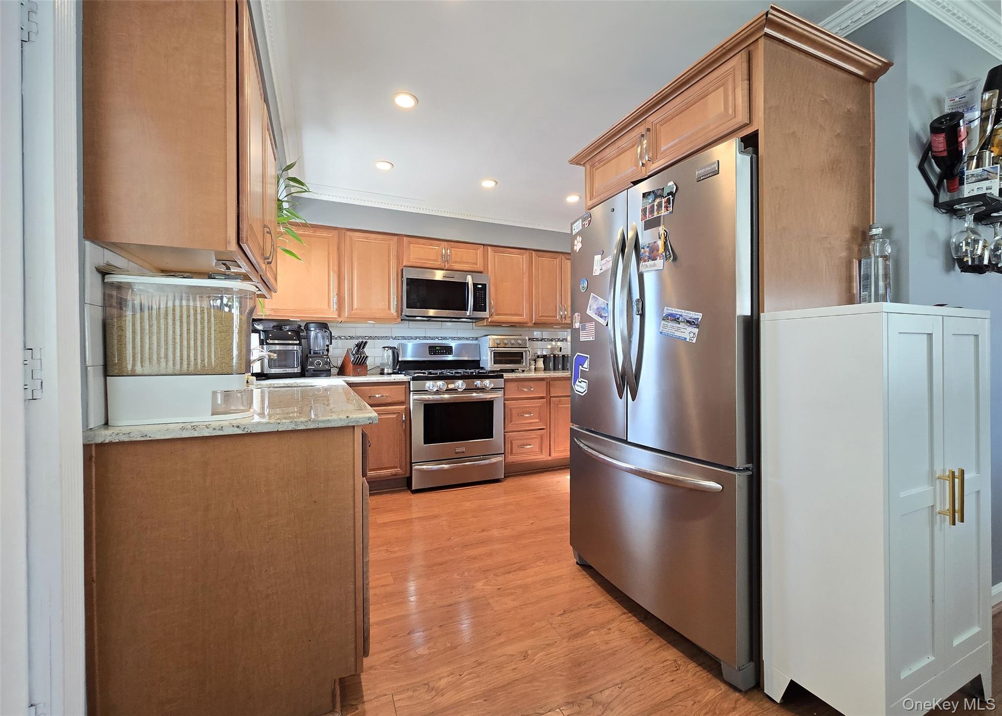 6 Virginia Road Centereach, NY 11720 - Photo 6 of 23 a kitchen with stainless steel appliances granite countertop a refrigerator a stove a sink dishwasher and a refrigerator with wooden floor