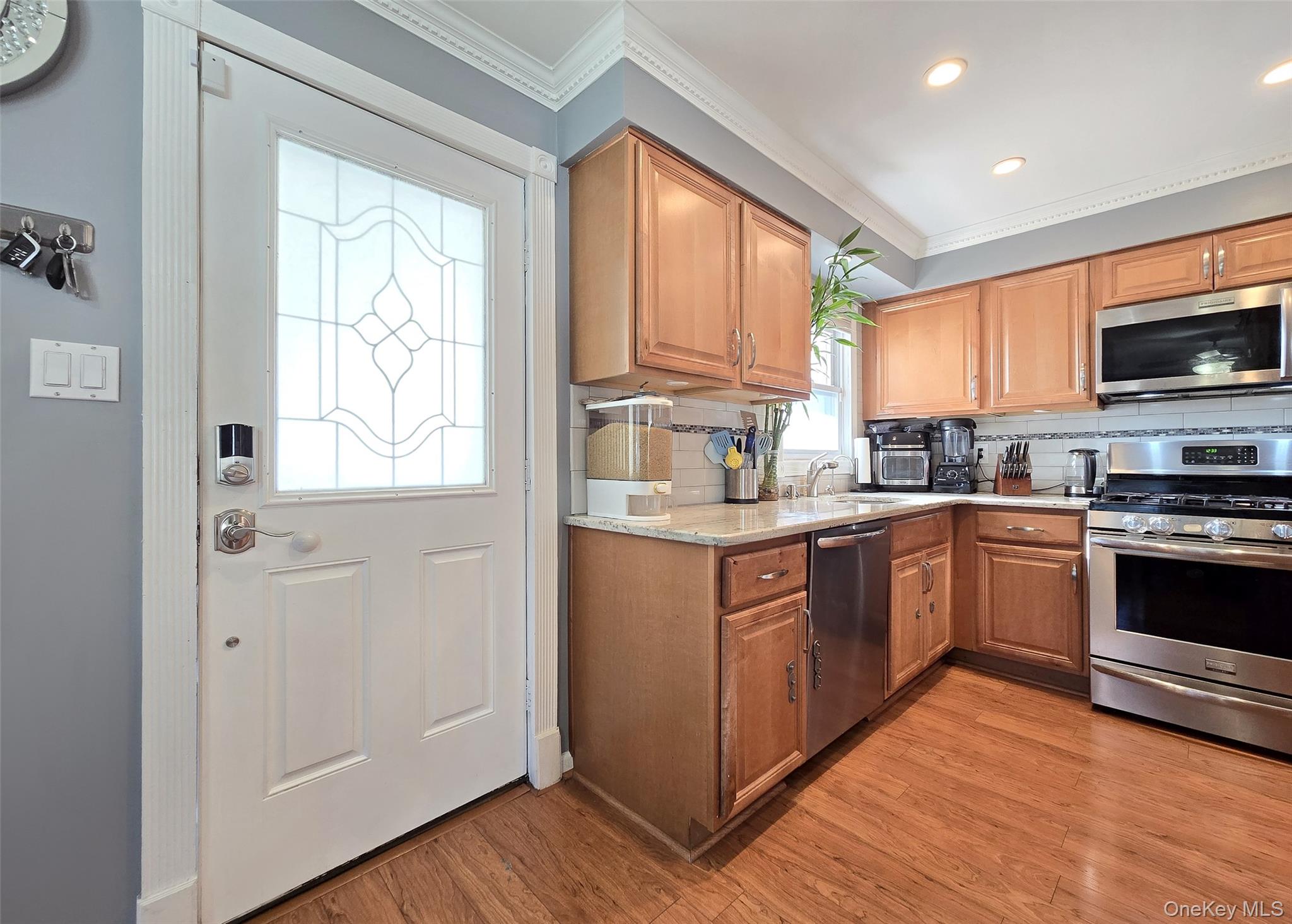 6 Virginia Road Centereach, NY 11720 - Photo 7 of 23 a kitchen with stainless steel appliances granite countertop a stove a sink and a microwave