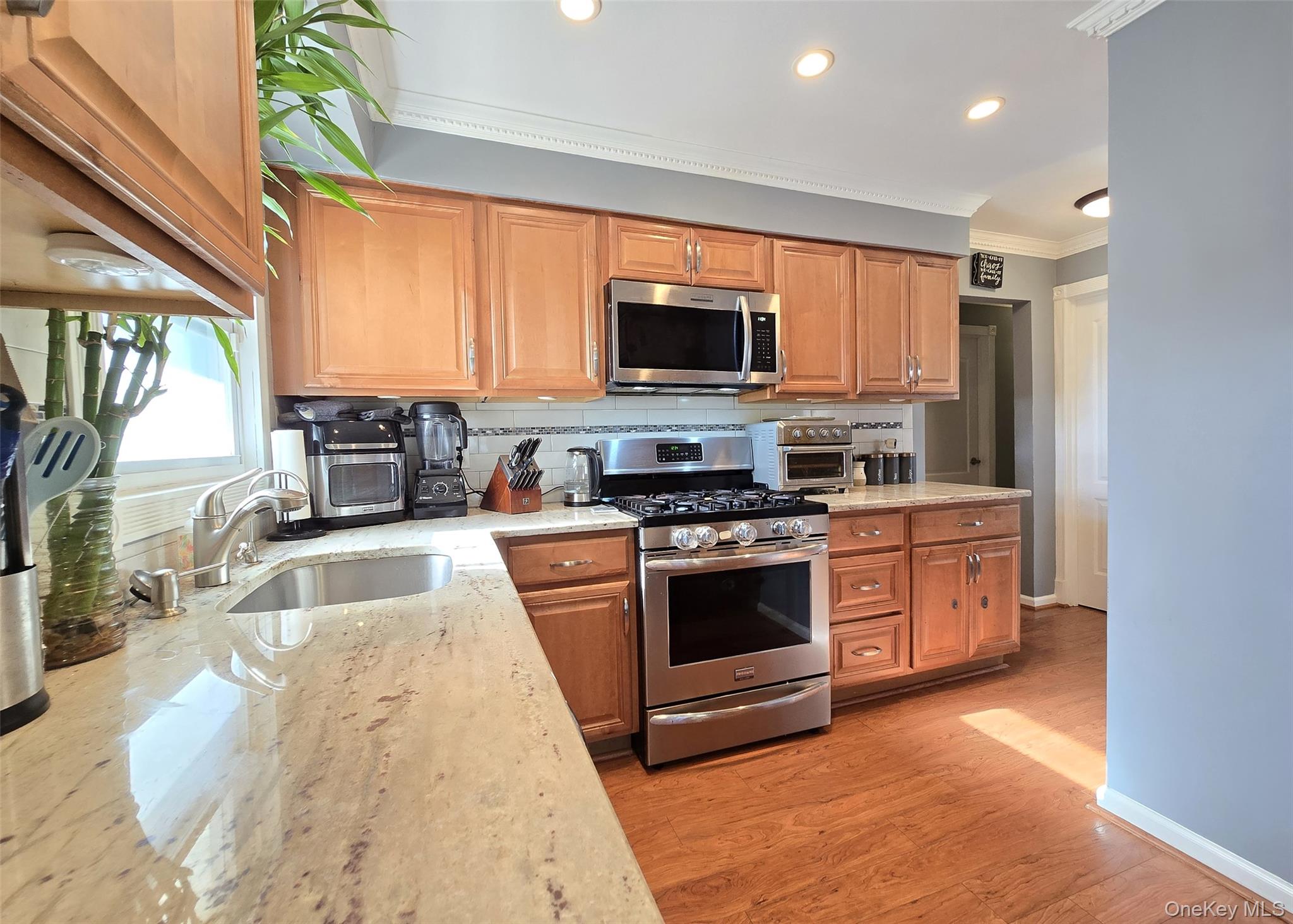 6 Virginia Road Centereach, NY 11720 - Photo 8 of 23 a large kitchen with stainless steel appliances granite countertop a stove a sink and a microwave