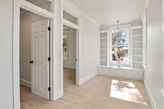 an empty room with windows and entrance