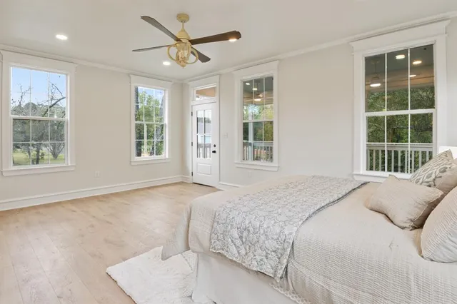 a bedroom with a large bed and a large window