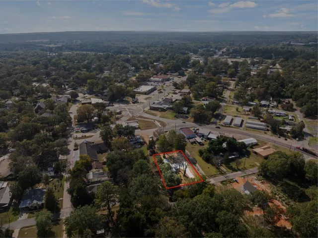 an aerial view of house with yard and mountain view in back