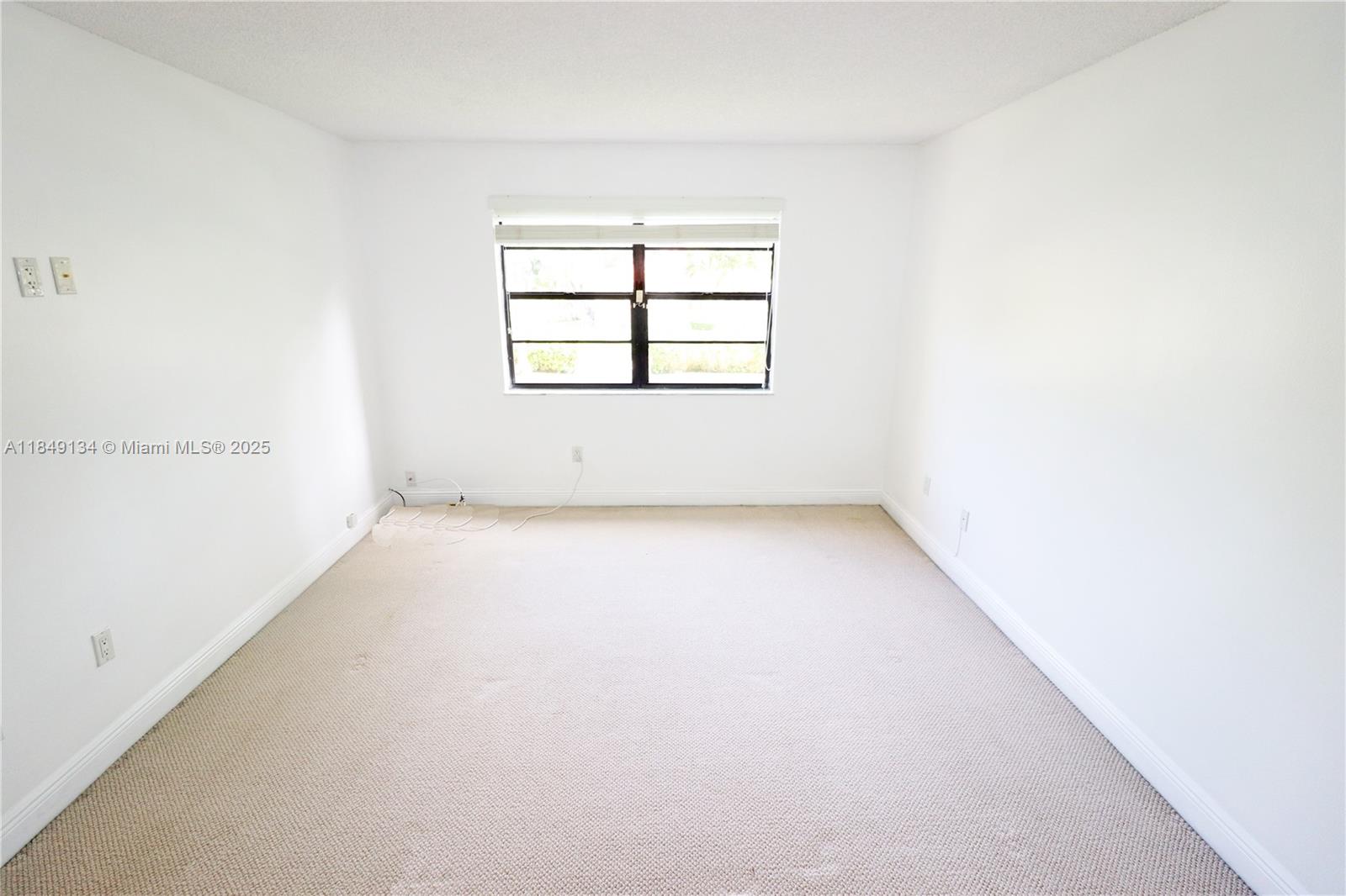 9301 Southwest 92nd Avenue, Unit A210 Miami, FL 33176 - Photo 12 of 25 an empty room with a window