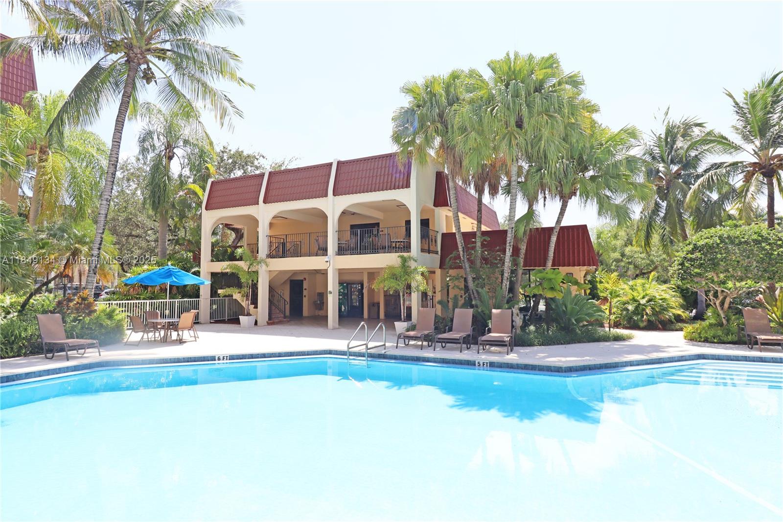 9301 Southwest 92nd Avenue, Unit A210 Miami, FL 33176 - Photo 18 of 25 a view of a building with a swimming pool