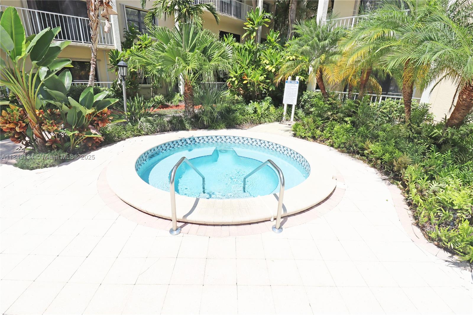 9301 Southwest 92nd Avenue, Unit A210 Miami, FL 33176 - Photo 20 of 25 a view of a swimming pool with a sink and a yard