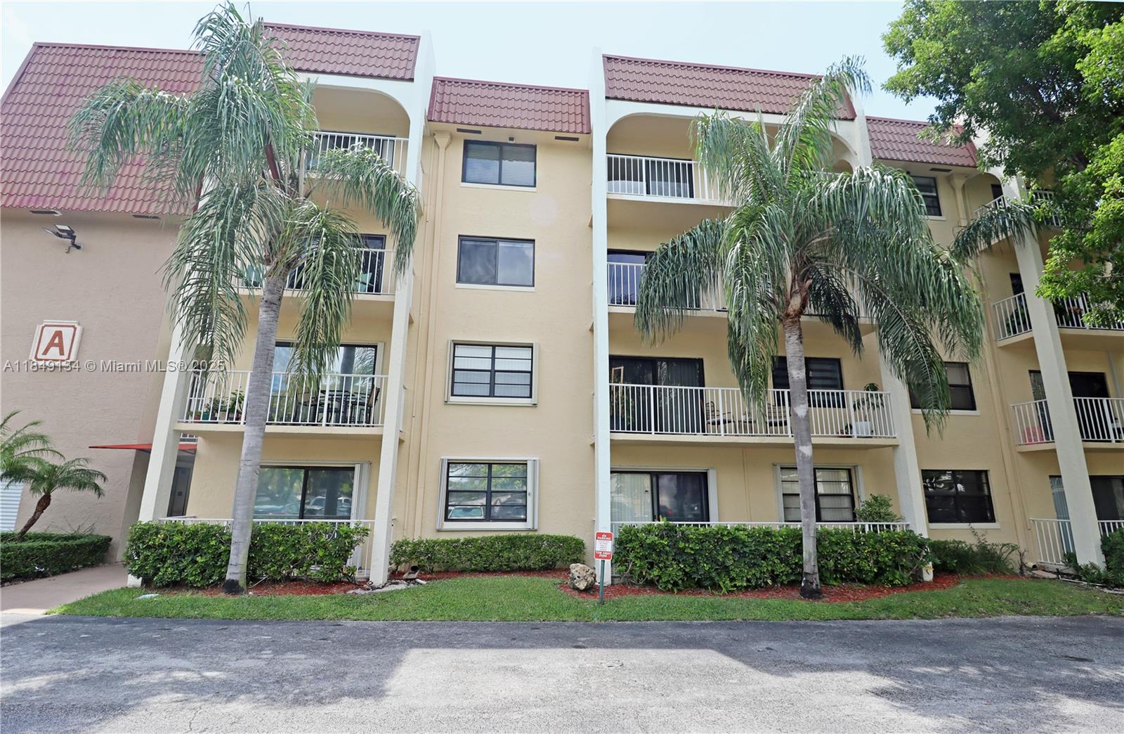 9301 Southwest 92nd Avenue, Unit A210 Miami, FL 33176 - Photo 2 of 25 a front view of a multi story building with yard