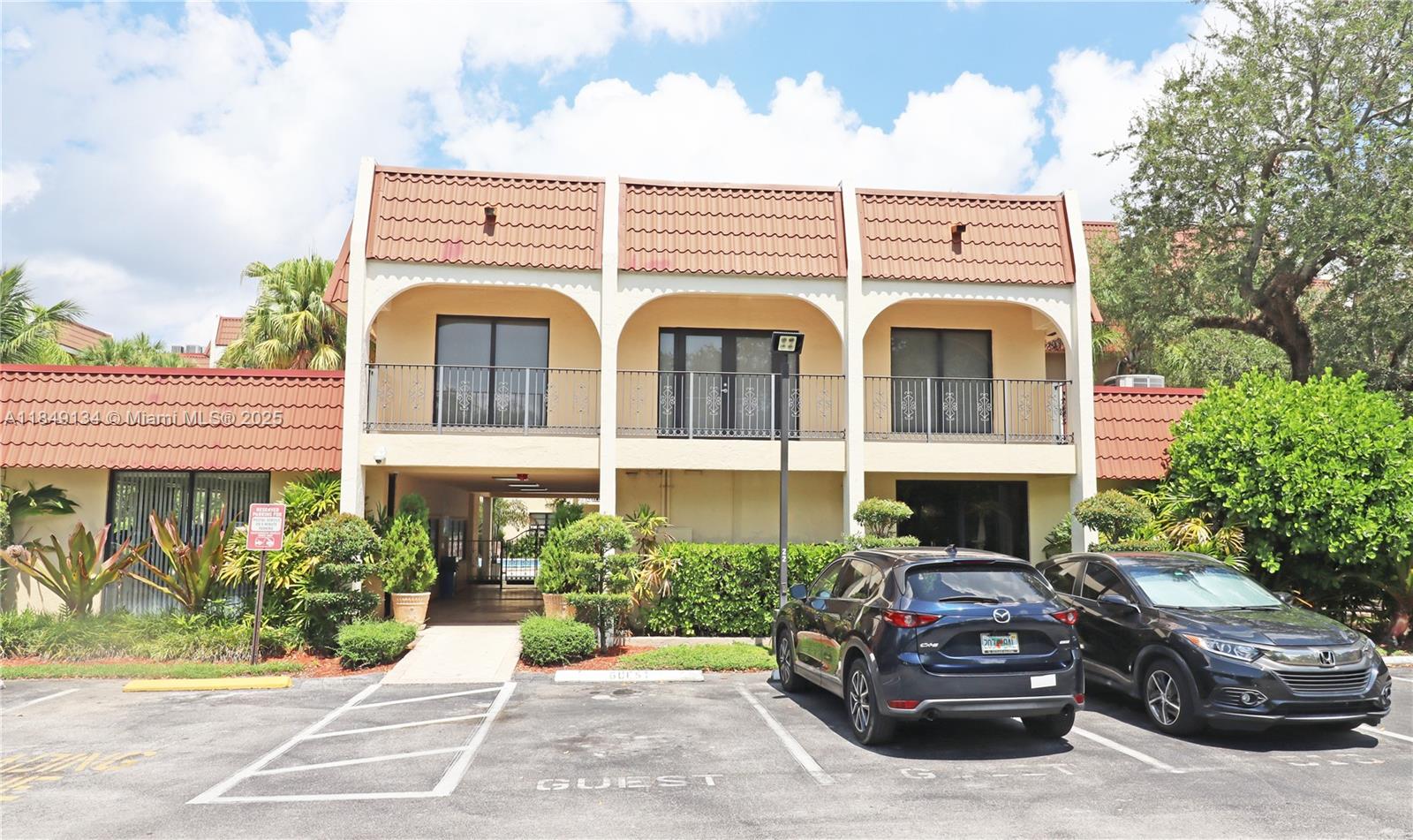 9301 Southwest 92nd Avenue, Unit A210 Miami, FL 33176 - Photo 25 of 25 a front view of a house with garden