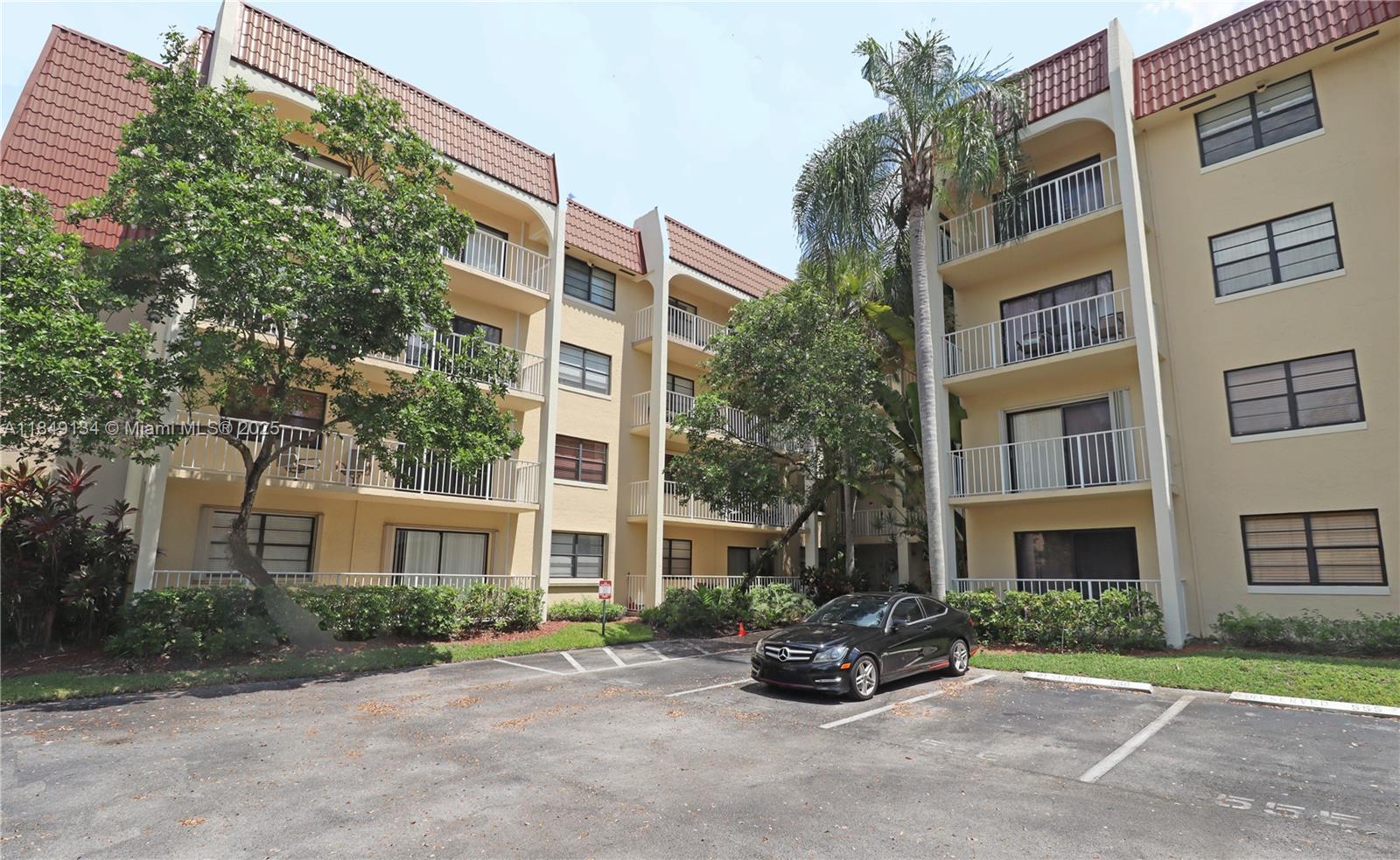 9301 Southwest 92nd Avenue, Unit A210 Miami, FL 33176 - Photo 4 of 25 a building view with a outdoor space