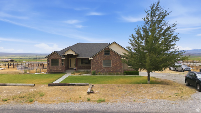 2567 West Rim Rock Drive Stockton, UT 84071 - Photo 53 of 64 Ranch-style residence featuring a brick facade, dark shingle roof, and a covered front entry