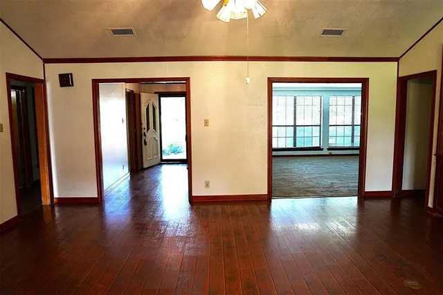 a view of a hallway with wooden floor