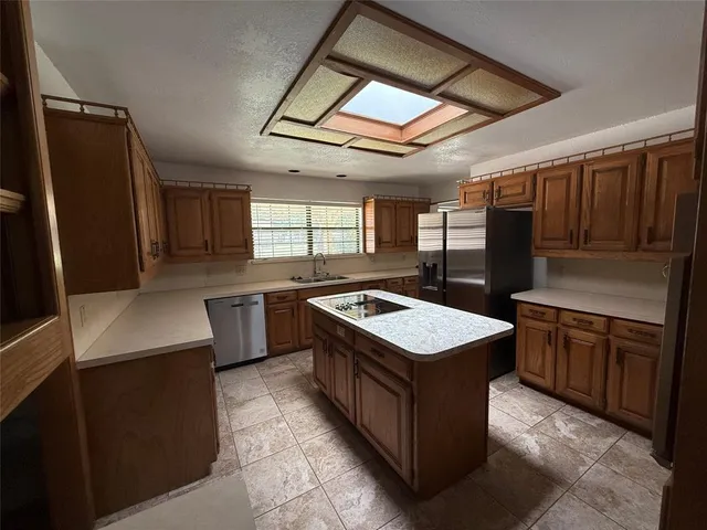 a kitchen with stainless steel appliances granite countertop a stove and a refrigerator