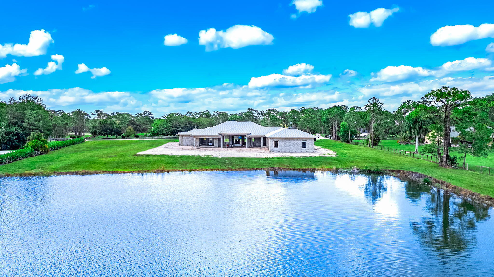 5593 Reynolds Road Lake Worth, FL 33449 - Photo 13 of 27 a view of a lake with a big yard and potted plants