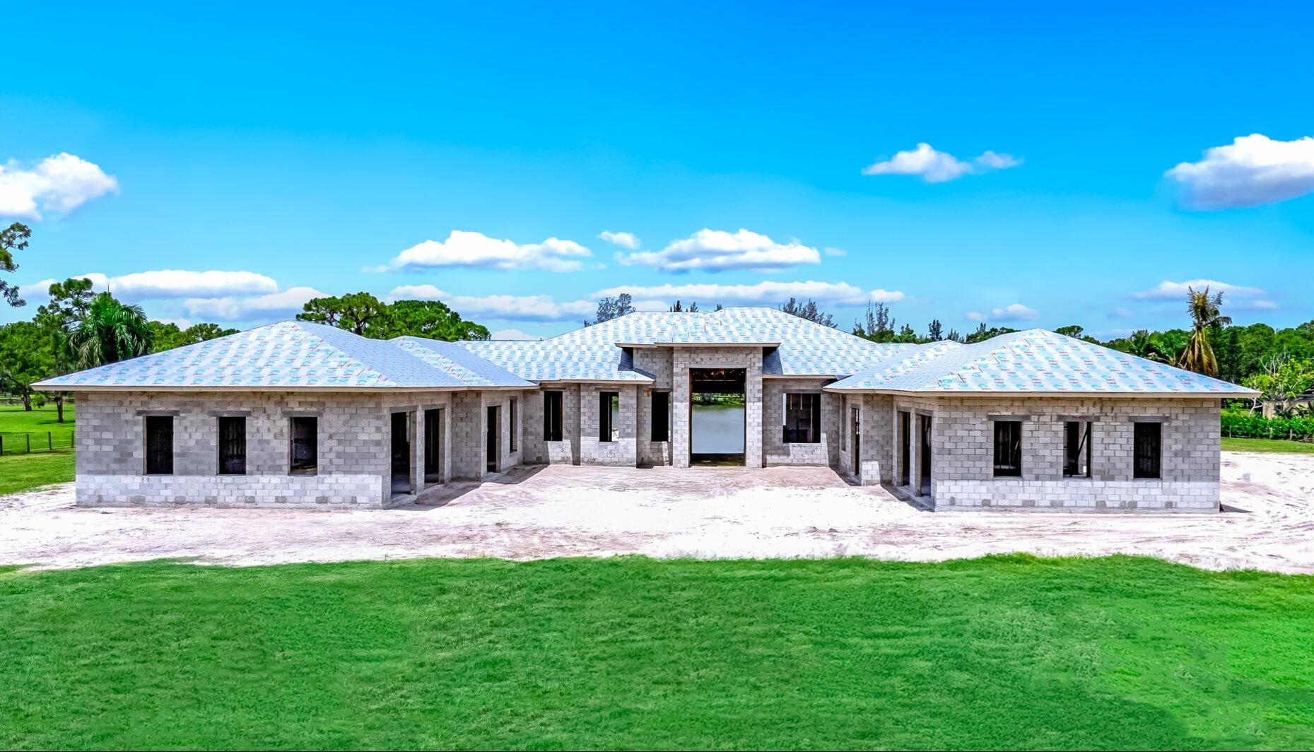5593 Reynolds Road Lake Worth, FL 33449 - Photo 7 of 27 a view of a house with a backyard and a patio