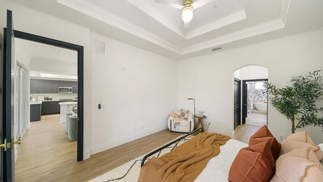 a bedroom with a bed and a potted plant