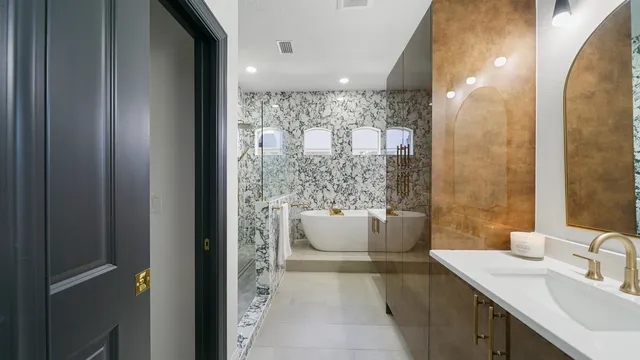 a bath tub sitting in a bathroom next to a sink