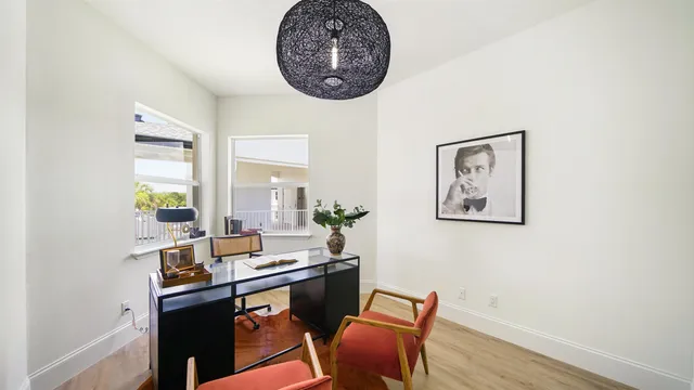 a view of a workspace with furniture and a window