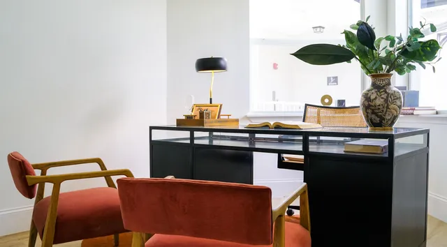 an empty room with wooden floor closet and windows