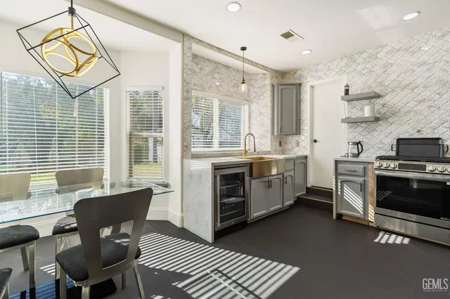 a kitchen with a stove a sink and a microwave