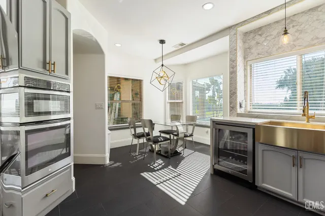 a living room with furniture windows and a chandelier