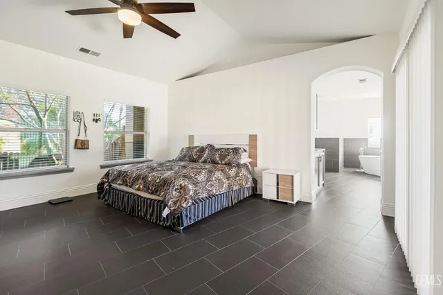 a bedroom with a bed and a large window