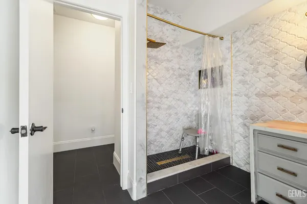 a bathroom with a shower and a sink