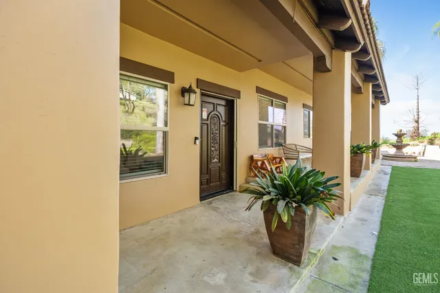 a view of a hallway with wooden floor and a potted plant