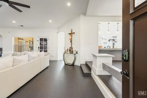 a living room with fireplace furniture and a table