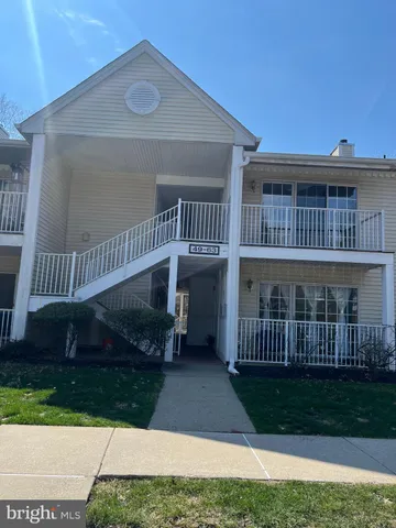 a view of a house with a yard and deck