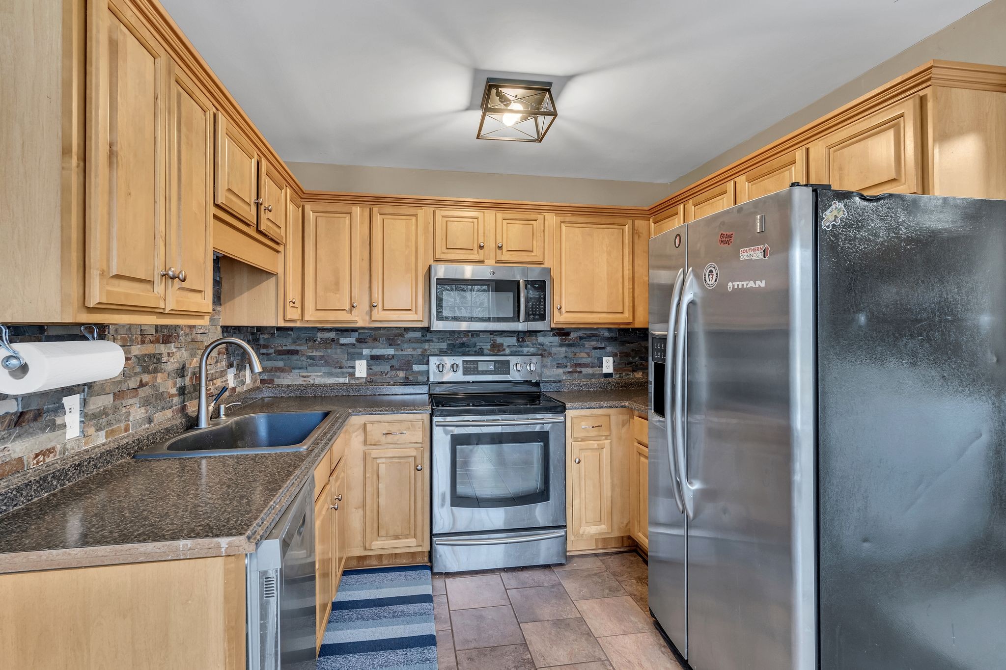 4237 Kedron Road Spring Hill, TN 37174 - Photo 11 of 48 a kitchen with stainless steel appliances granite countertop a sink stove refrigerator and cabinets