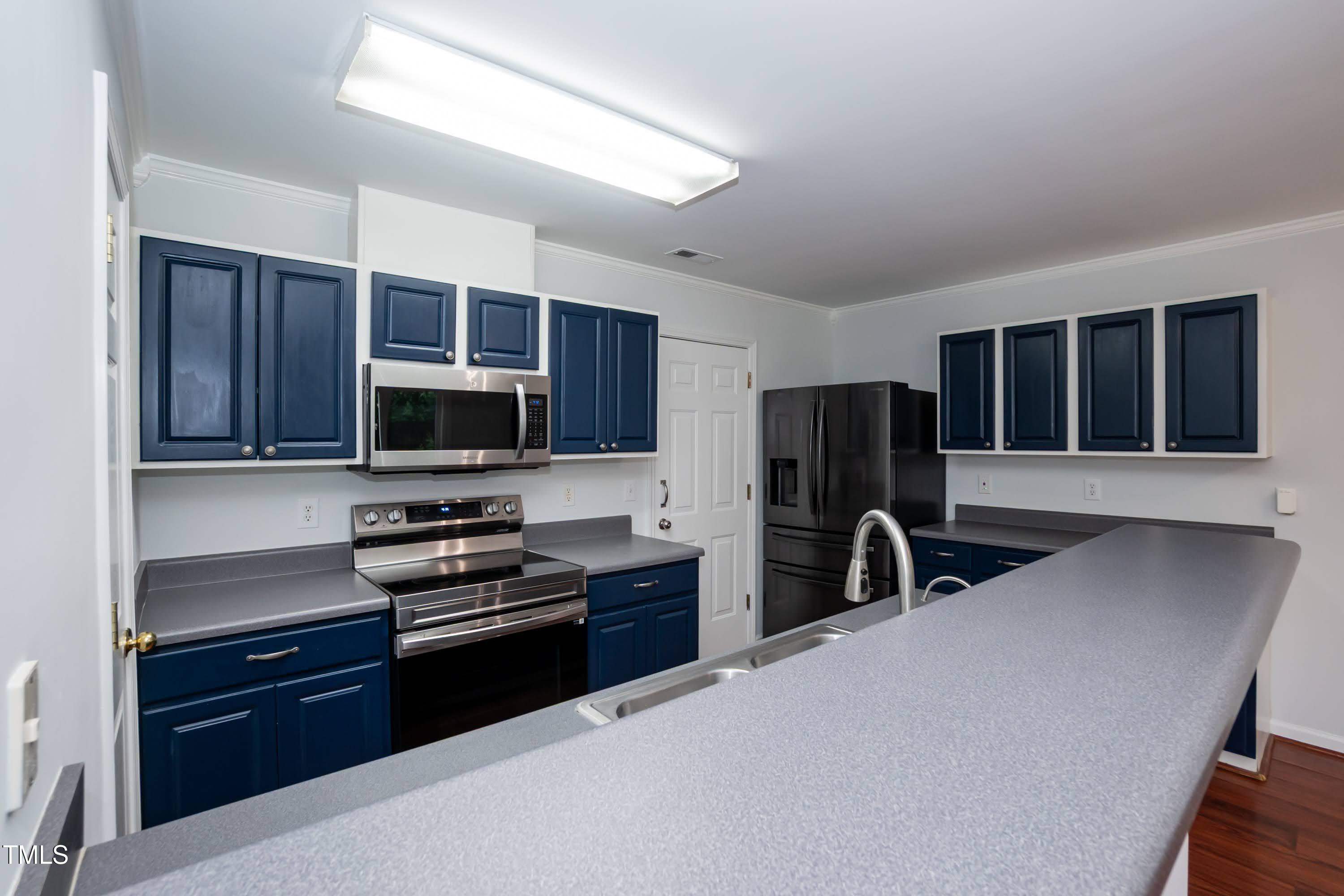 8 Kingfisher Way Durham, NC 27713 - Photo 11 of 25 a kitchen with stainless steel appliances granite countertop a refrigerator and a stove top oven