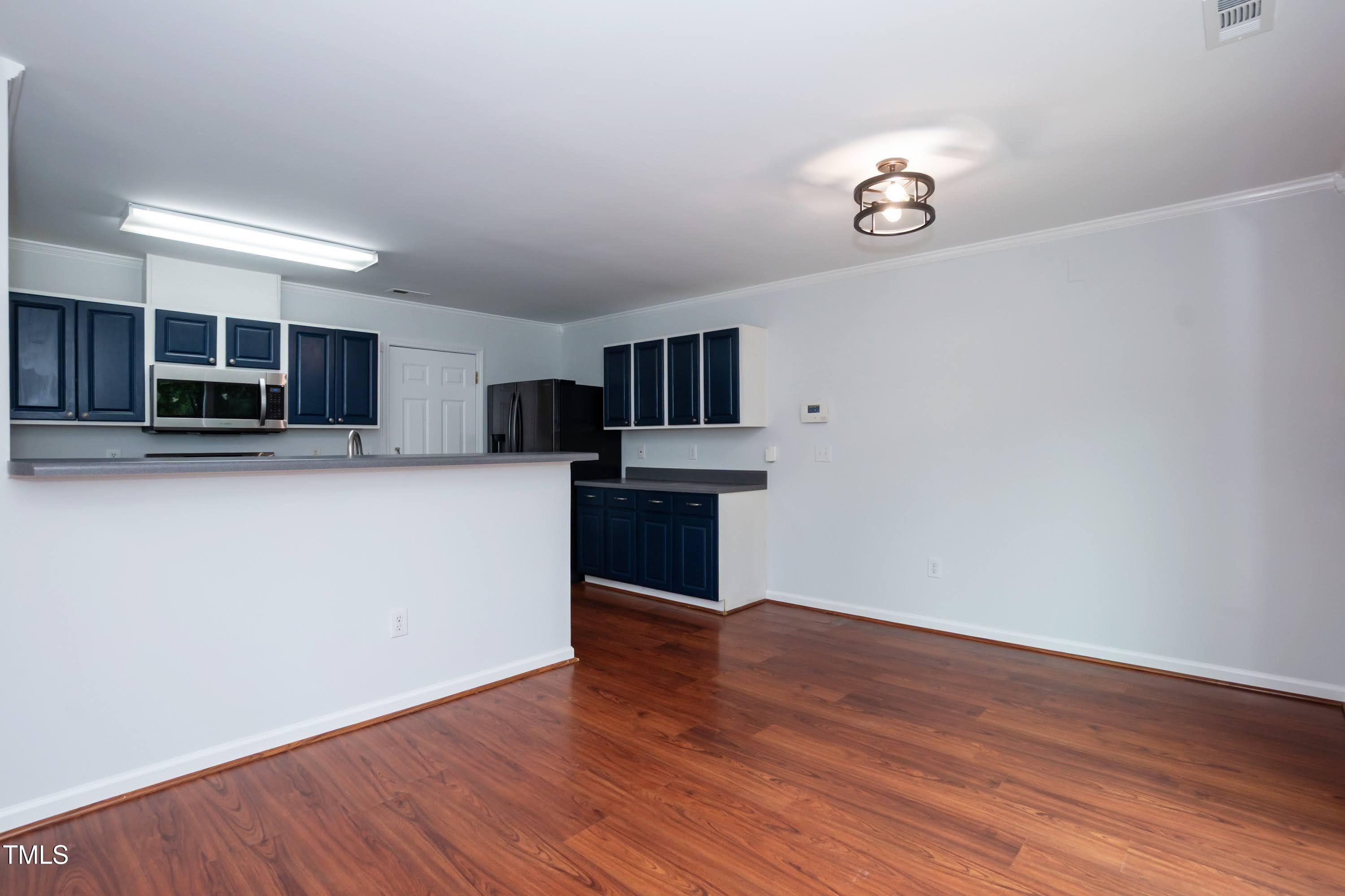 8 Kingfisher Way Durham, NC 27713 - Photo 13 of 25 a kitchen with stainless steel appliances a stove top oven a sink and a microwave