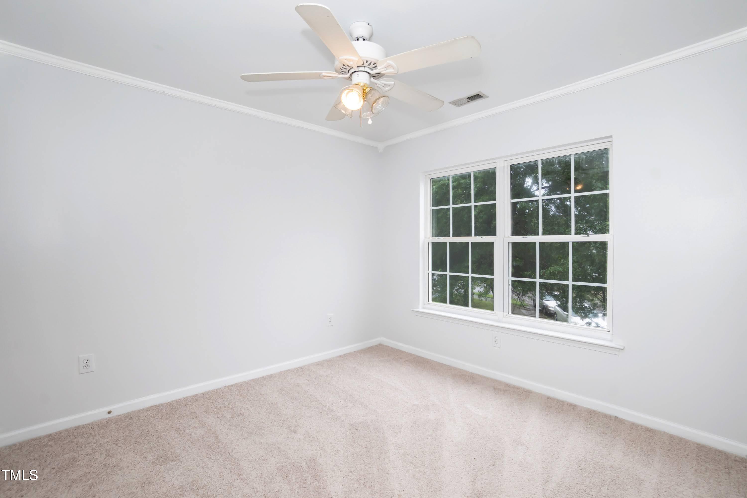8 Kingfisher Way Durham, NC 27713 - Photo 21 of 25 an empty room with windows and ceiling fan