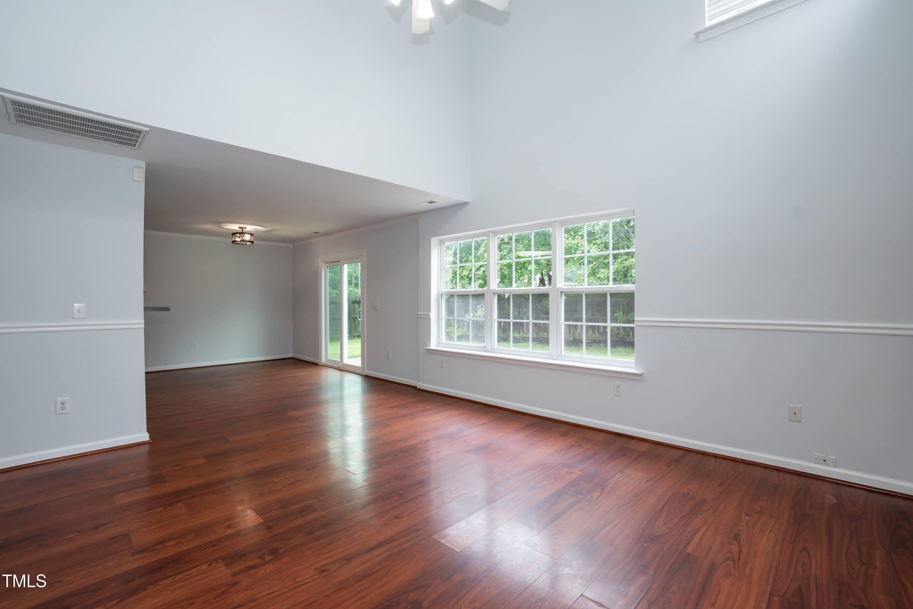 8 Kingfisher Way Durham, NC 27713 - Photo 5 of 25 a view of an empty room with wooden floor and a window