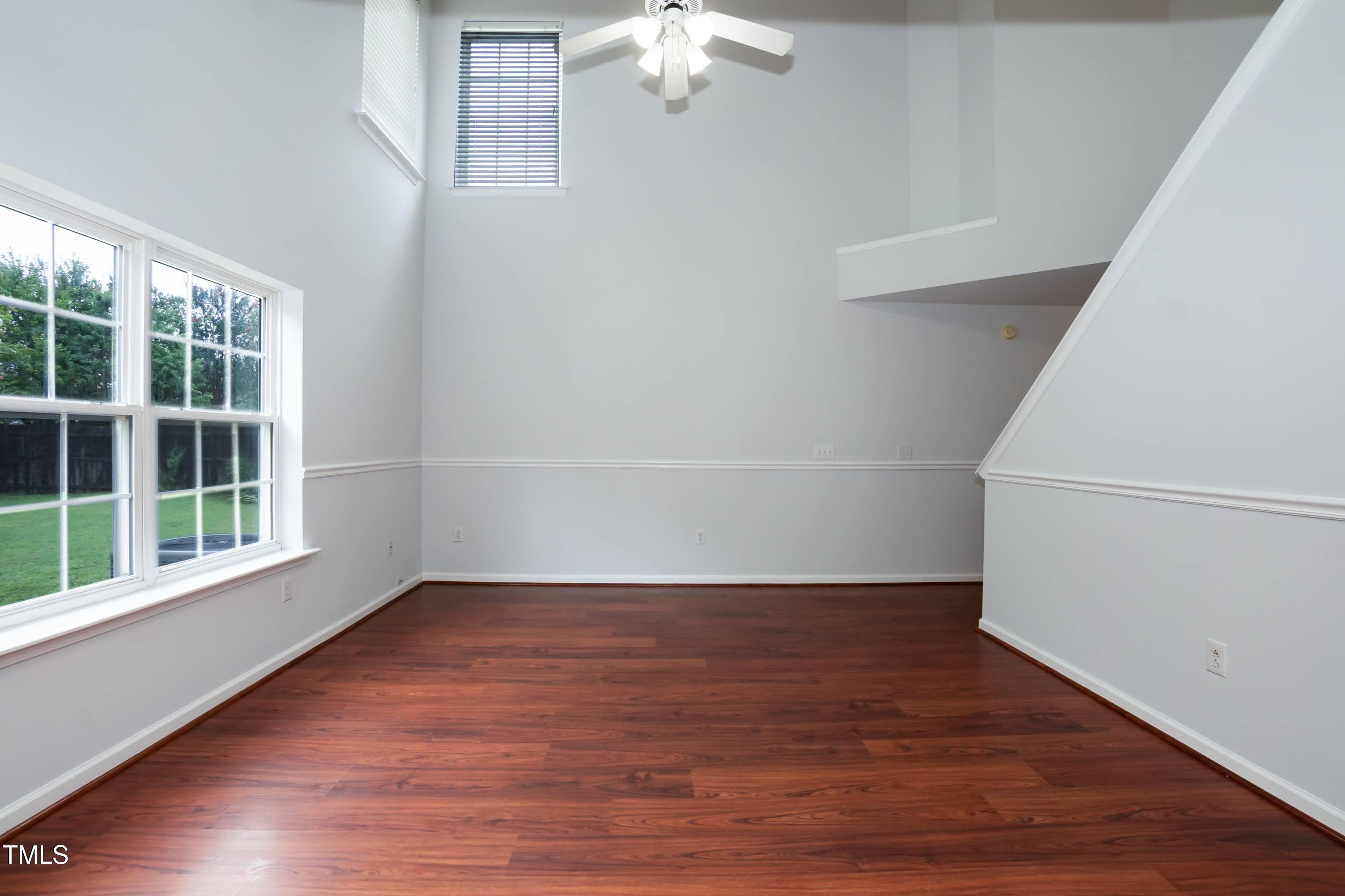 8 Kingfisher Way Durham, NC 27713 - Photo 6 of 25 a view of an empty room with wooden floor and a window