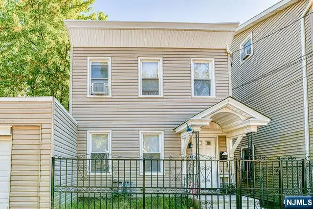a view of a white house with many windows