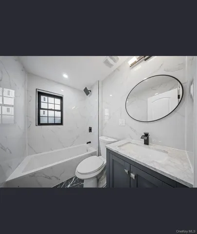 a bathroom with a toilet a sink and a mirror