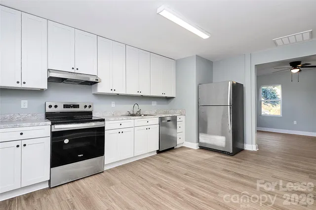 a kitchen with a white cabinets and white appliances