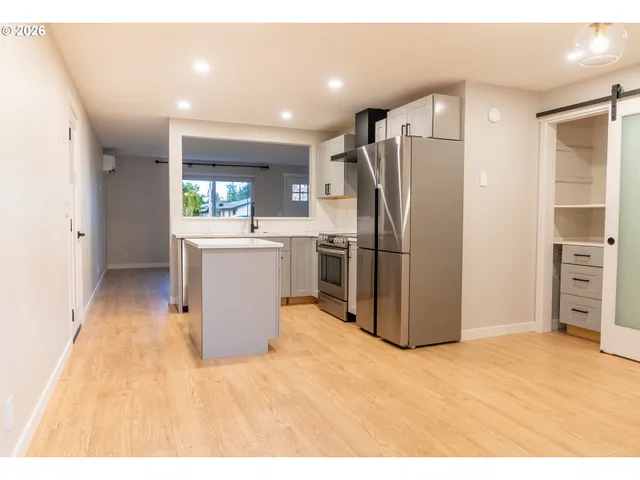 a kitchen with stainless steel appliances a refrigerator and a stove
