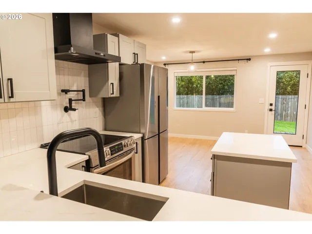 a kitchen with a refrigerator and a sink
