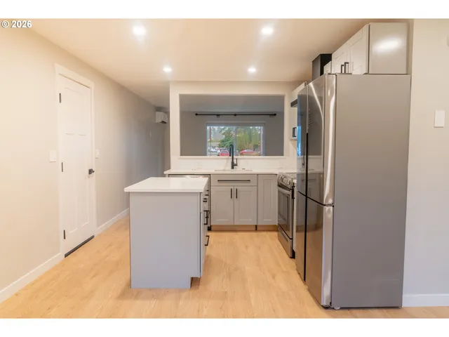 a utility room with cabinets washer and dryer