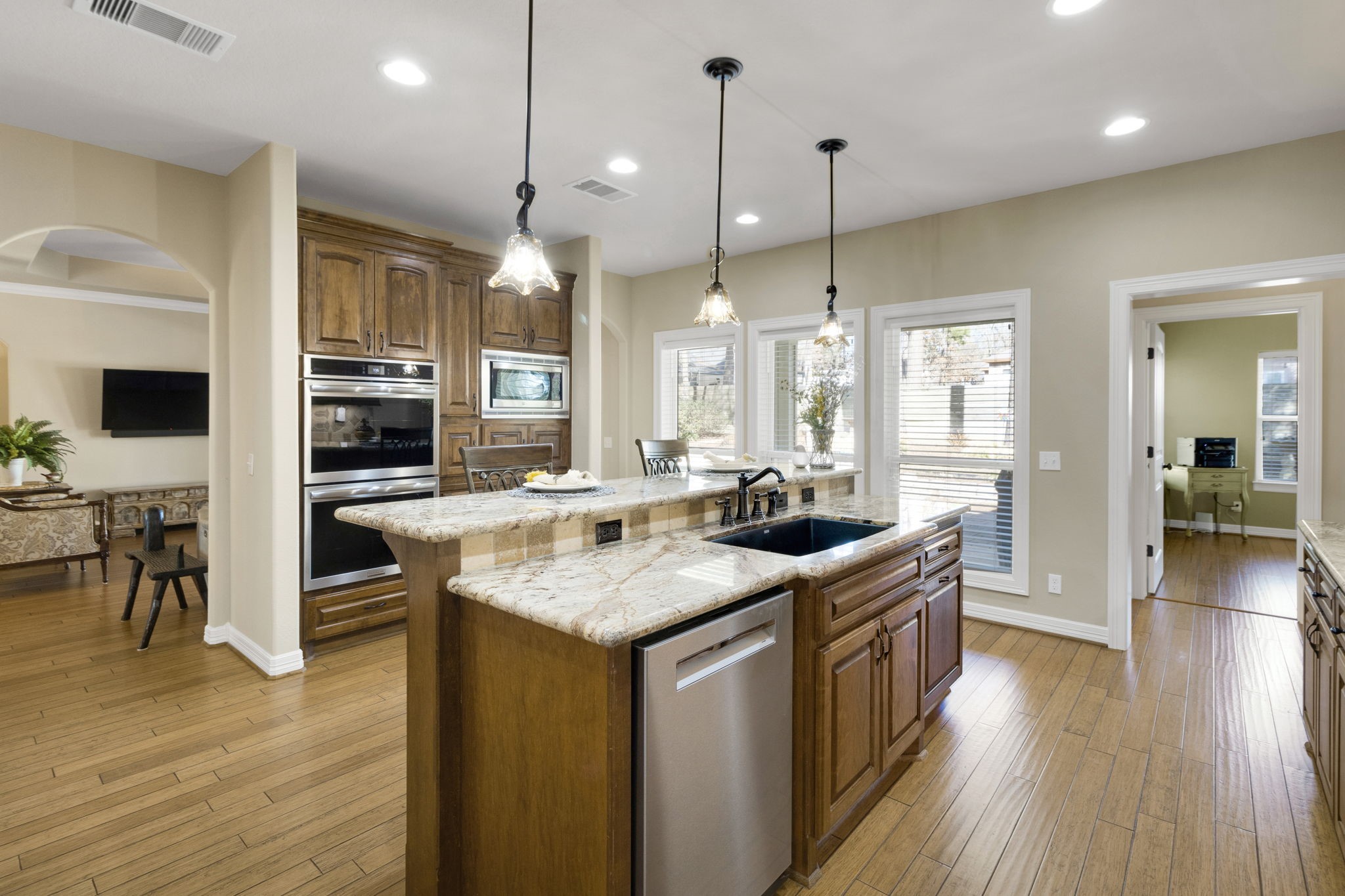 1040 Kings Way Coldspring, TX 77331 - Photo 24 of 50 a kitchen with stainless steel appliances granite countertop wooden floors and view of living room
