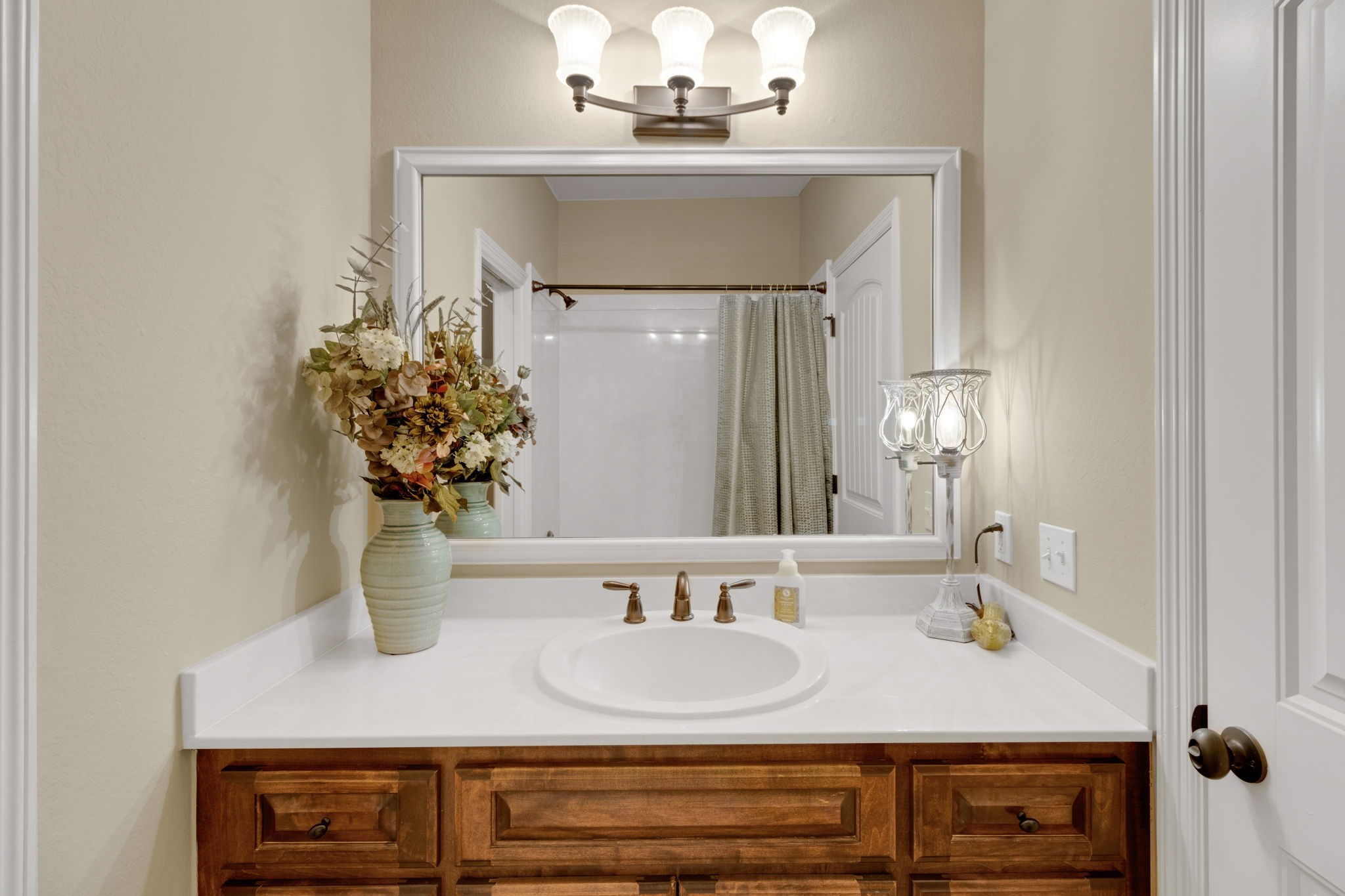 1040 Kings Way Coldspring, TX 77331 - Photo 36 of 50 Guest bath featuring tub/shower, warm cabinetry and a polished look