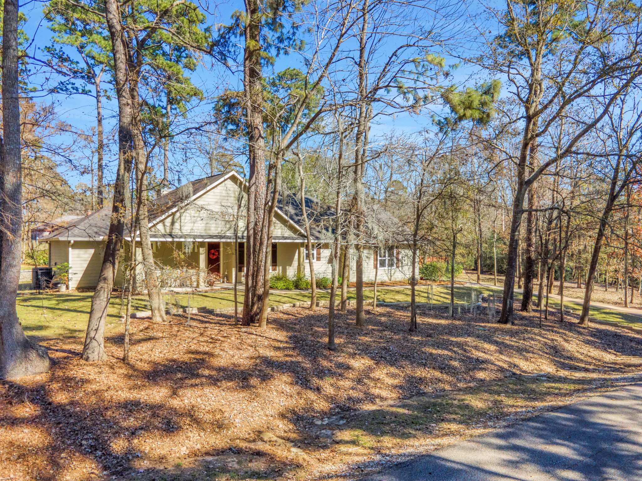 1040 Kings Way Coldspring, TX 77331 - Photo 4 of 50 Enjoy carpet-like zoysia grass in the front and back yards and mulched flower beds