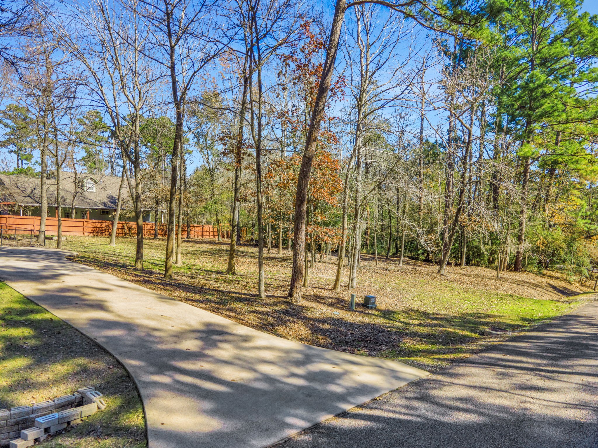 1040 Kings Way Coldspring, TX 77331 - Photo 7 of 50 This third lot has no improvements on it, but the 0.29 acres of extra land creates space, shade and a peaceful buffer