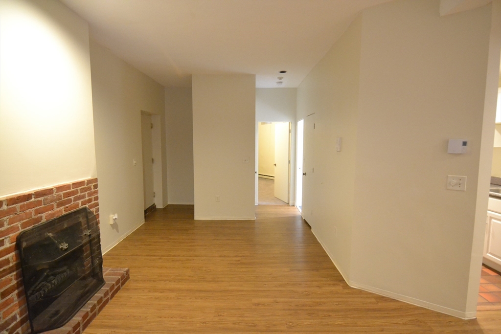 67 St Germain Street, Unit 232 Boston, MA 02115 - Photo 7 of 15 a view of a livingroom with wooden floor and staircase