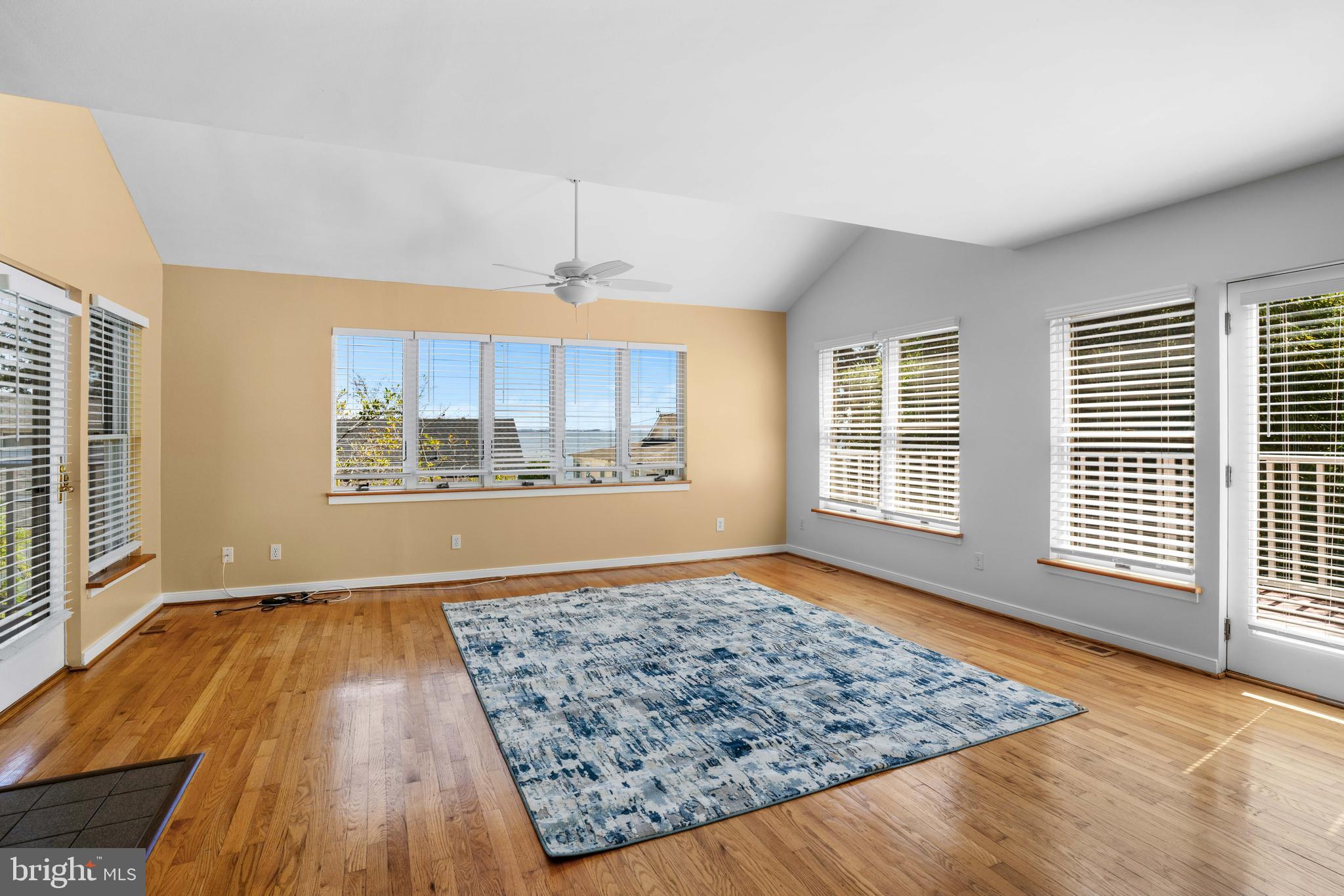 4734 Oak Road Shady Side, MD 20764 - Photo 11 of 48 a view of an empty room with a window and wooden floor