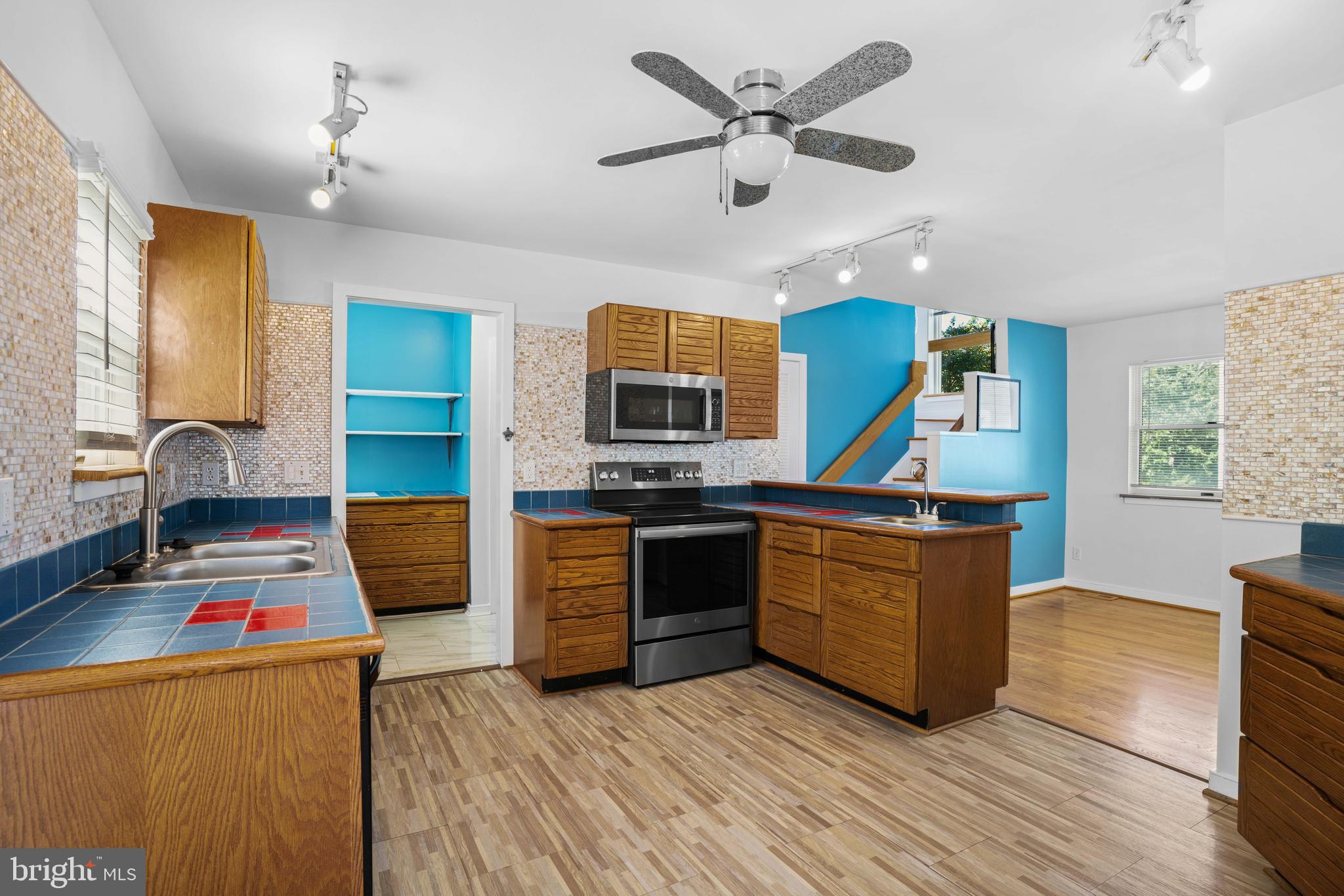 4734 Oak Road Shady Side, MD 20764 - Photo 15 of 48 a kitchen with stainless steel appliances granite countertop a sink and a stove with wooden floors