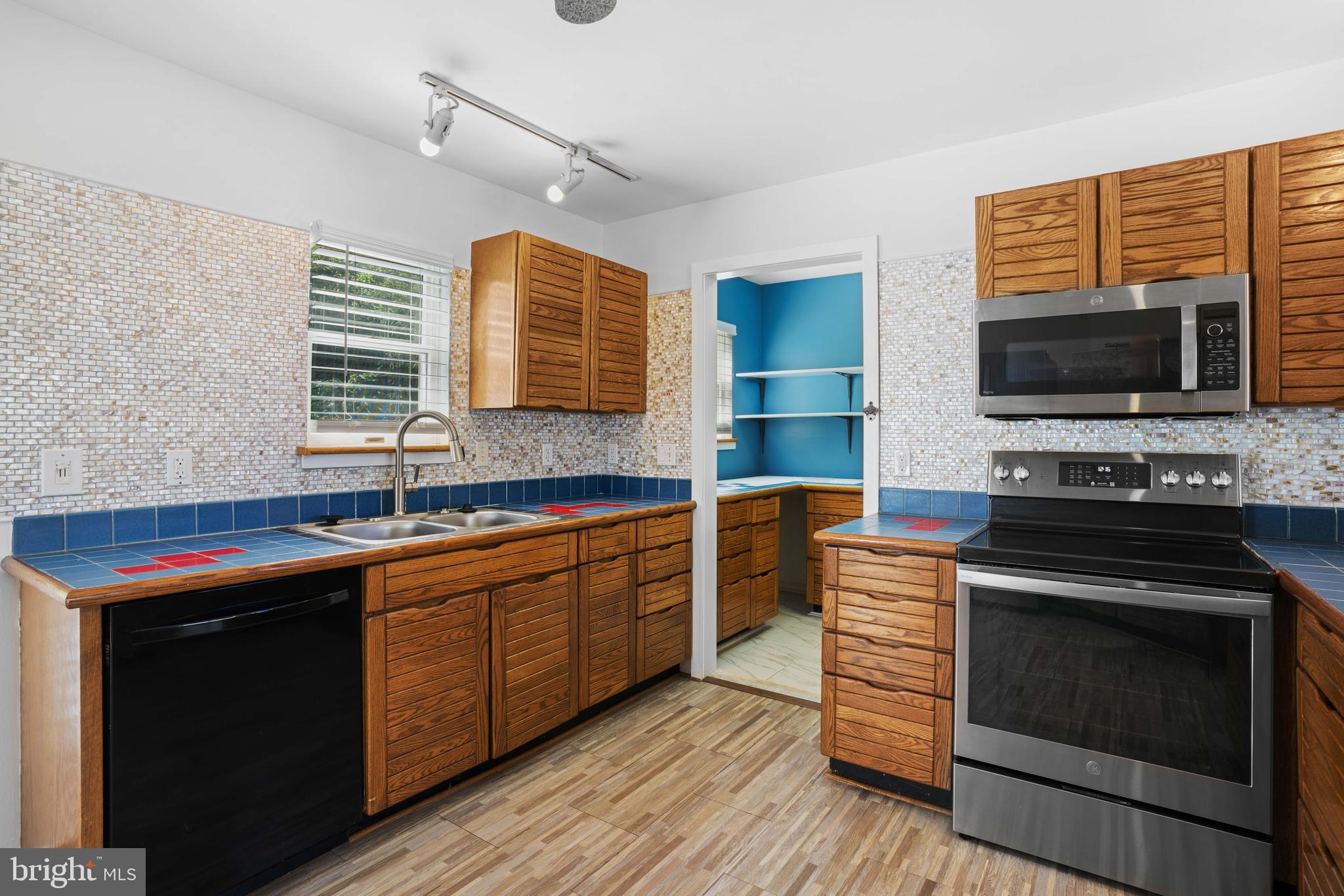 4734 Oak Road Shady Side, MD 20764 - Photo 16 of 48 a kitchen with stainless steel appliances kitchen island granite countertop a stove and a sink