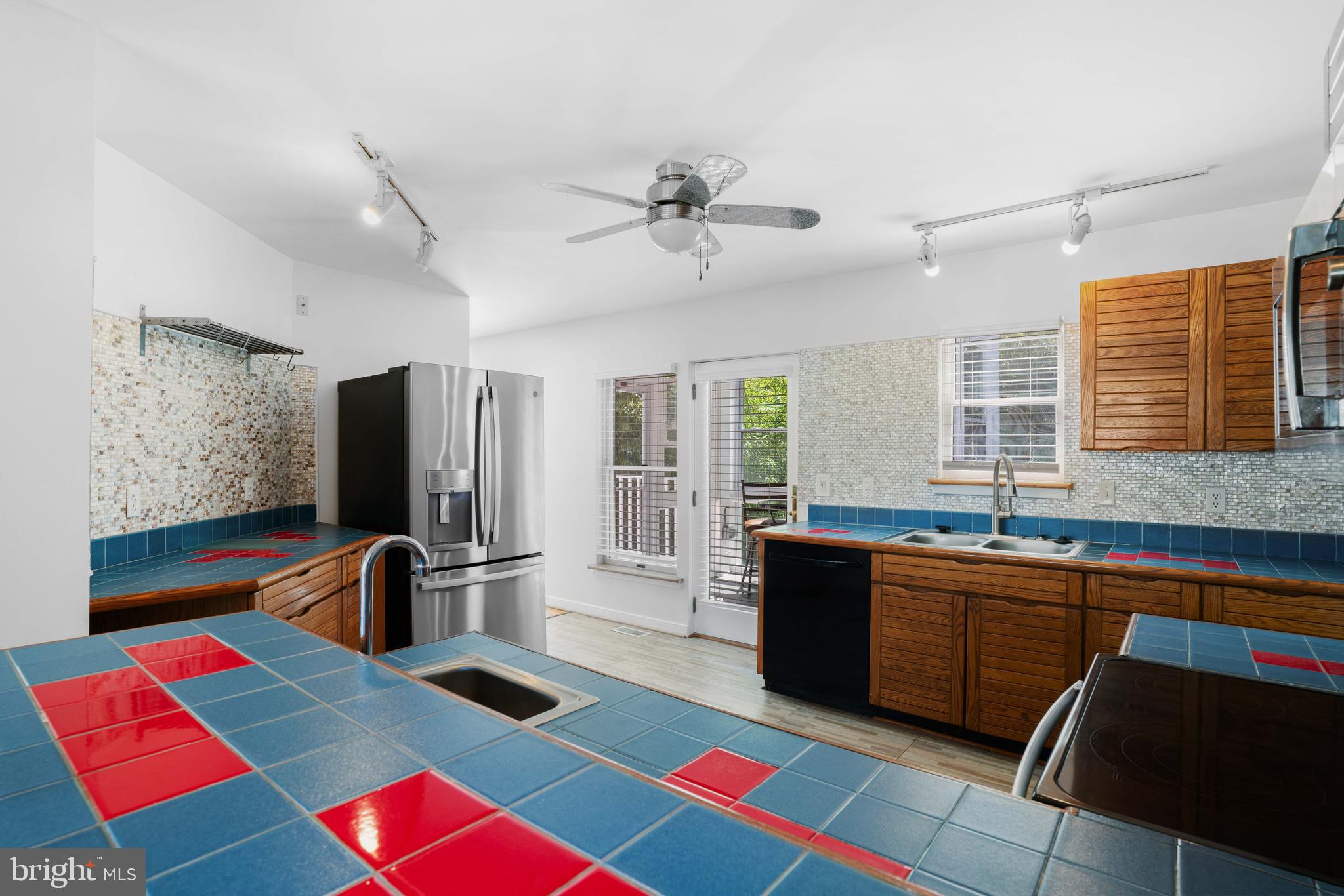 4734 Oak Road Shady Side, MD 20764 - Photo 18 of 48 a kitchen with a refrigerator sink and wooden floor